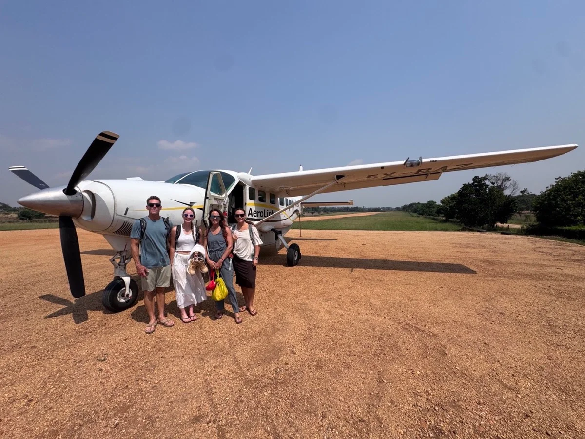 Travelers beside a small bush plane