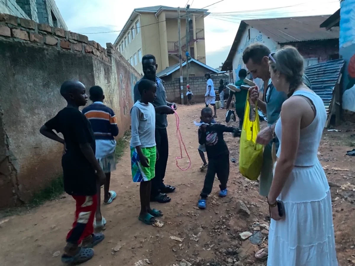 Travelers meeting children and local residents along a neighborhood street