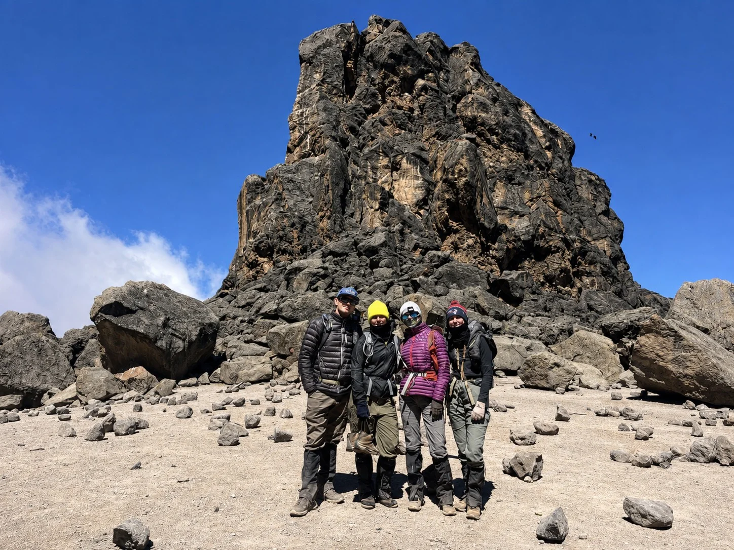 Kilimanjaro climbers beside a high-altitude rock formation