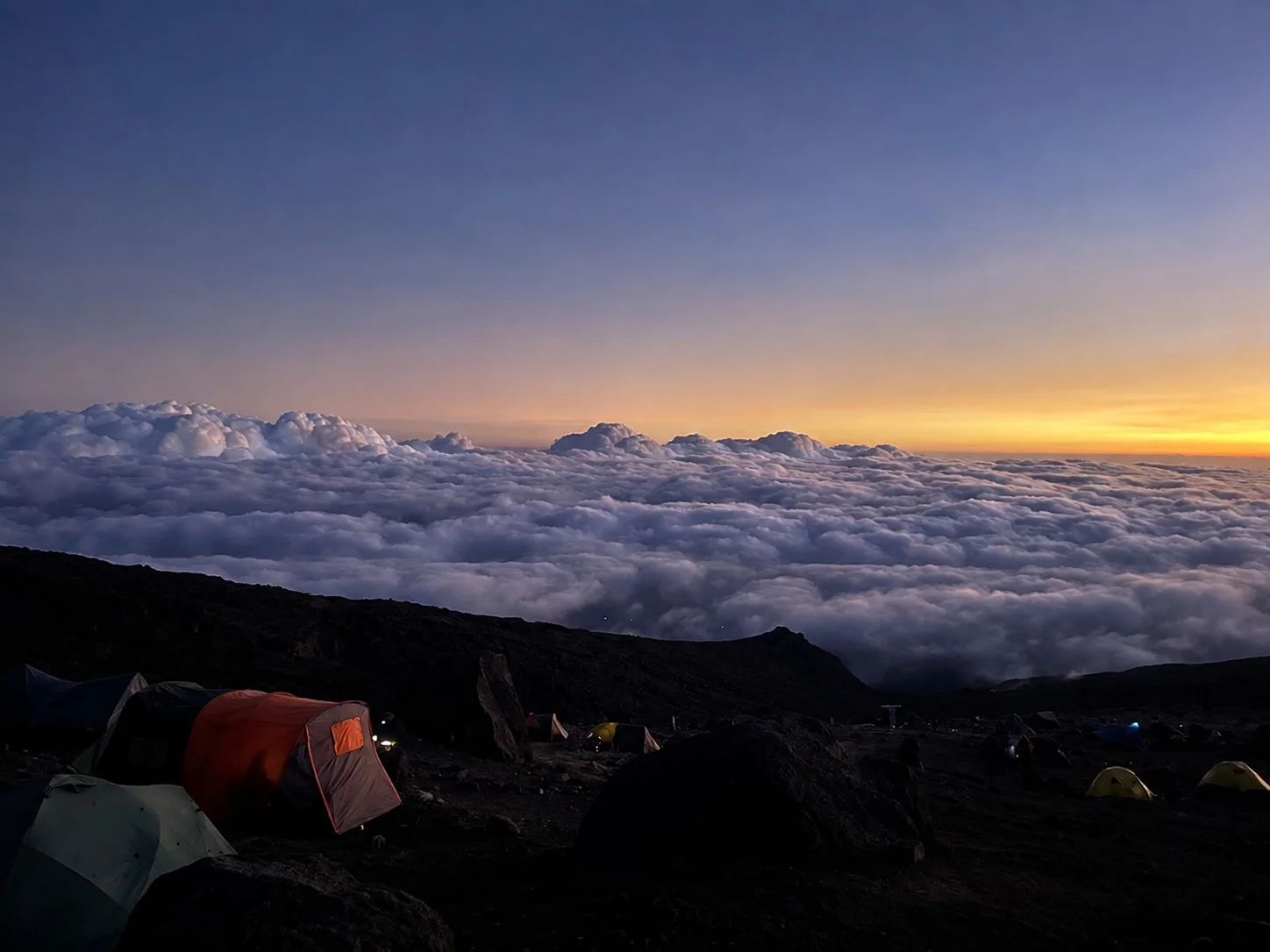 Purple and orange sunrise above the clouds on Kilimanjaro