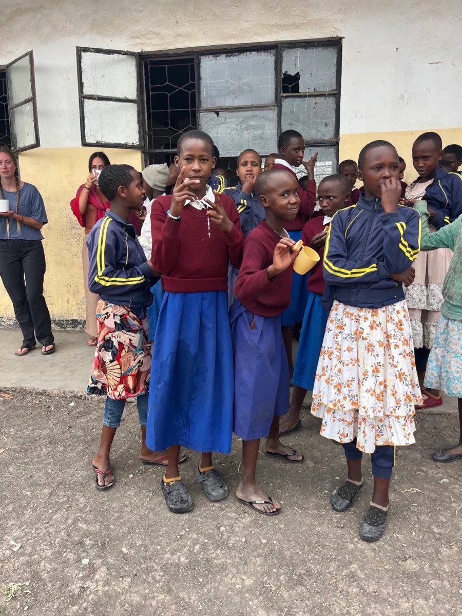 Tanzanian students gathered outside their classroom